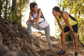 Couple of athletes taking break in mountain race